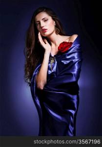 portrait of a beautiful woman in violet dress whith rose