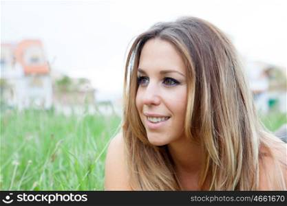 Portrait of a beautiful woman lying on the grass