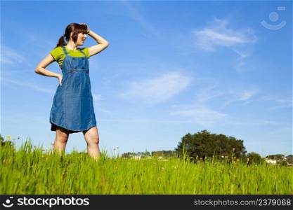 Portrait of a beautiful woman on a green meadow