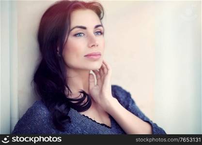 Portrait of a beautiful woman outdoors in the city, gorgeous model posing over urban background, natural and authentic beauty