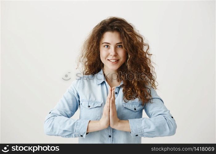 Portrait of a beautiful woman praying, isolated on a gray background. Portrait of a beautiful woman praying, isolated on a gray background.