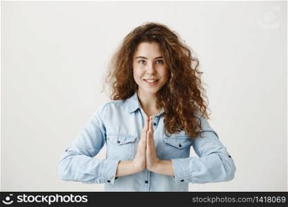Portrait of a beautiful woman praying, isolated on a gray background. Portrait of a beautiful woman praying, isolated on a gray background.
