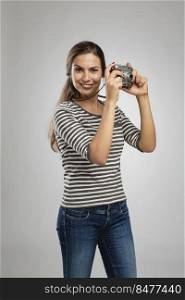 Portrait of a beautiful woman shooting with a vintage camera