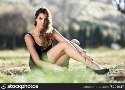 Portrait of a beautiful woman siting in a urban park