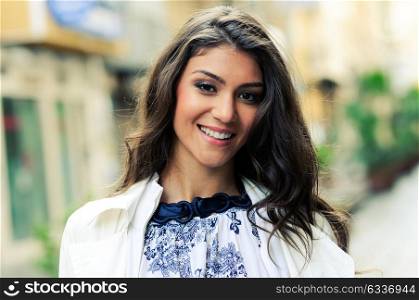 Portrait of a beautiful woman smiling in urban background