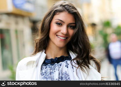 Portrait of a beautiful woman smiling in urban background