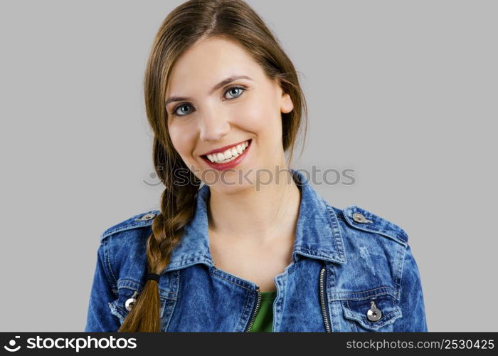 Portrait of a beautiful woman smiling over a grey background