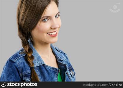 Portrait of a beautiful woman smiling over a grey background