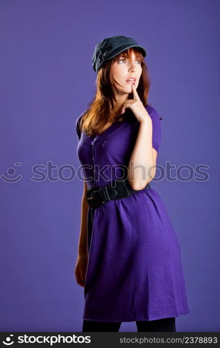 Portrait of a beautiful woman with a lovely espression, over a violet background