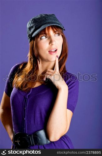 Portrait of a beautiful woman with a lovely espression, over a violet background