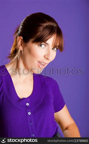 Portrait of a beautiful woman with a lovely espression, over a violet background