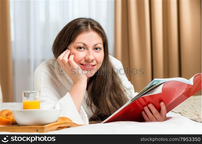 portrait of a beautiful woman with a magazine in the room