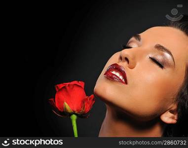 Portrait of a beautiful woman with a red rose