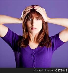 Portrait of a beautiful woman with a worried expression, over a violet background