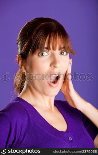 Portrait of a beautiful woman with an astonish expression, over a violet background