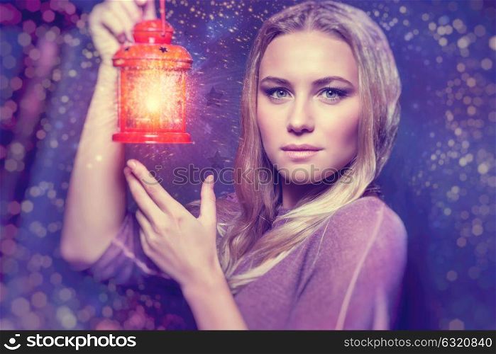 Portrait of a beautiful woman with glowing lantern at nighttime, magical Christmas night, Christmastime fairytale