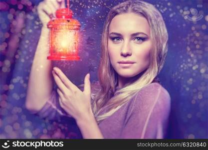 Portrait of a beautiful woman with glowing lantern at nighttime, magical Christmas night, Christmastime fairytale