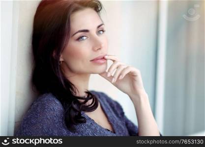 Portrait of a beautiful woman with natural makeup, gorgeous model posing over urban background, natural and authentic beauty