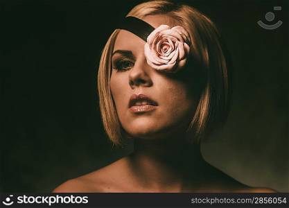 Portrait of a beautiful woman with rosebud on fillet