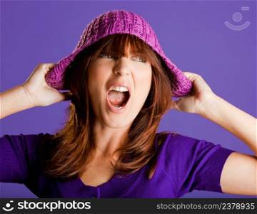 Portrait of a beautiful woman yelling, over a violet background
