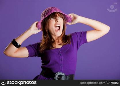 Portrait of a beautiful woman yelling, over a violet background