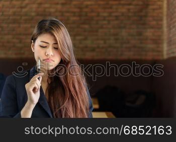 Portrait of a beautiful young asian professional businesswoman thinking something