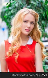 portrait of a beautiful young blonde in a red dress