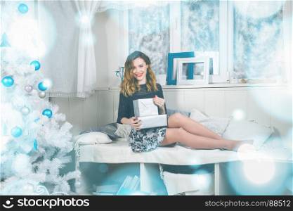 Portrait of a beautiful young brown-haired woman near a Christmas tree. Christmas background