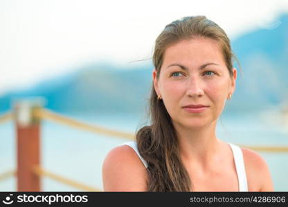portrait of a beautiful young brunette on the pier