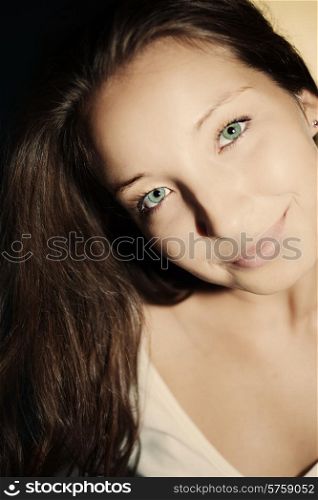 Portrait of a beautiful young brunette woman with green eyes