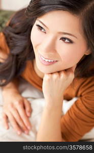 Portrait of a beautiful young Chinese Asian Oriental woman resting on her hand