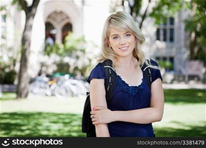 Portrait of a beautiful young girl standing in the campus
