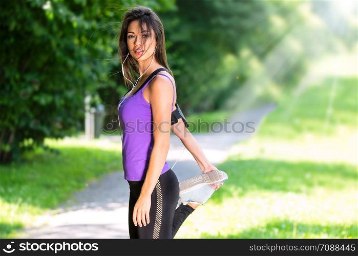 Portrait of a beautiful young girl stretching before jogging in the park on a sunny morning (copy space)