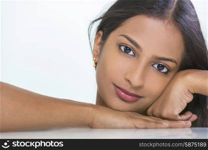 Portrait of a beautiful young Indian Asian woman or girl resting on her hand