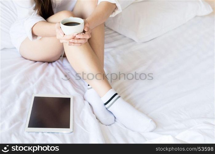 Portrait of a beautiful young lady drinking her morning coffee in her bedroom, Soft light and comfort natural lifestyle