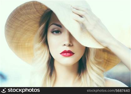 Portrait of a beautiful young lady in a straw hat