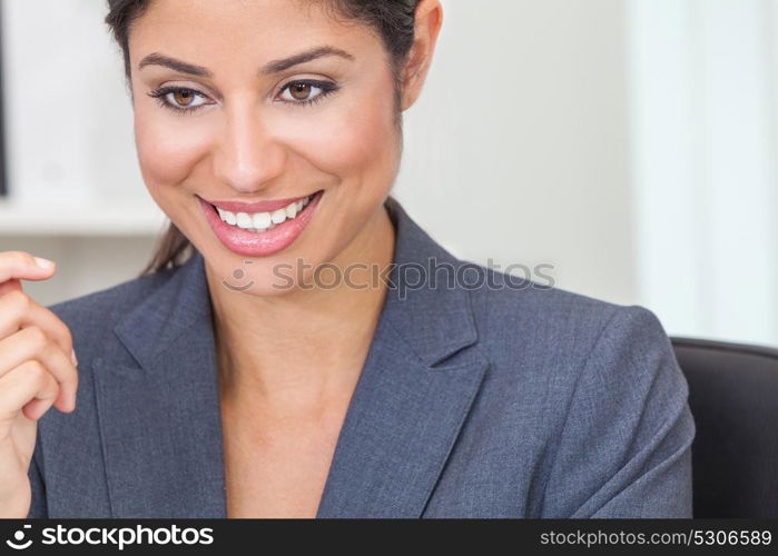 Portrait of a beautiful young Latina Hispanic woman or businesswoman wearing smart business suit in her office