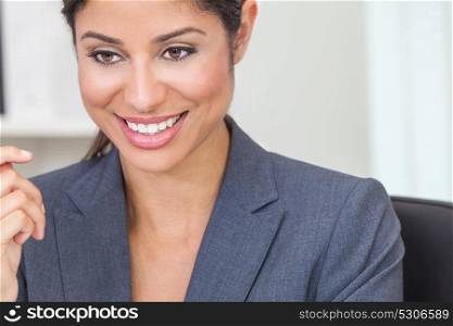 Portrait of a beautiful young Latina Hispanic woman or businesswoman wearing smart business suit in her office