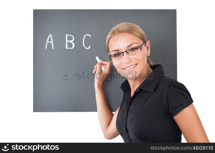 Portrait of a beautiful young teacher isolated on white background, cute female writing letters on the blackboard, teaching in an elementary school
