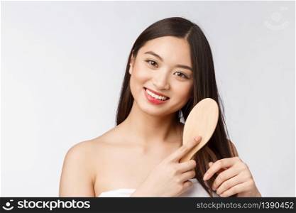 portrait of a beautiful young woman comb wonderful hair isolated on white background, asian beauty.. portrait of a beautiful young woman comb wonderful hair isolated on white background, asian beauty