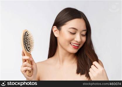 portrait of a beautiful young woman comb wonderful hair isolated on white background, asian beauty.. portrait of a beautiful young woman comb wonderful hair isolated on white background, asian beauty