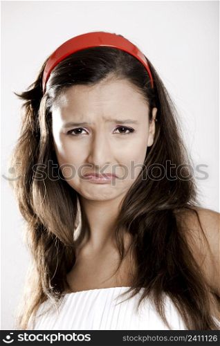 Portrait of a beautiful young woman crying, isolated on white