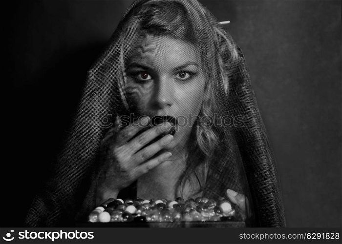Portrait of a beautiful young woman in a mourning veil