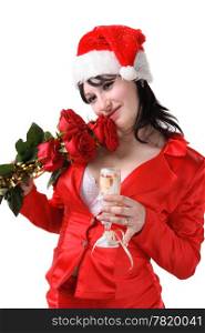 Portrait of a beautiful young woman in a red suit and hat of Santa Claus with red roses and champagne on the white background