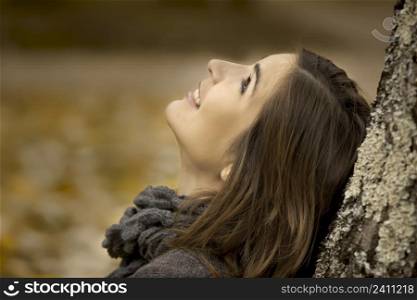 Portrait of a beautiful young woman in outdoor relaxing and enjoying the nature