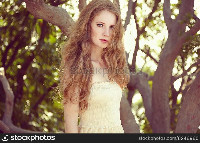 Portrait of a beautiful young woman in summer garden. Girl on nature. Spring mood. Fashion beauty