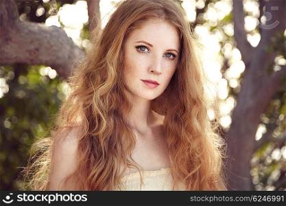 Portrait of a beautiful young woman in summer garden. Girl on nature. Spring mood. Fashion beauty