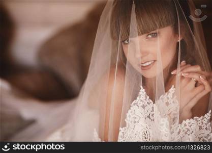 Portrait of a beautiful young woman. Makeup and hairstyle in bride. Close up. Wedding morning. Gentle, Tender emotion on the face.. Portrait of a beautiful young woman. Makeup and hairstyle in bride. Close up. Wedding morning. Gentle, Tender emotion on the face
