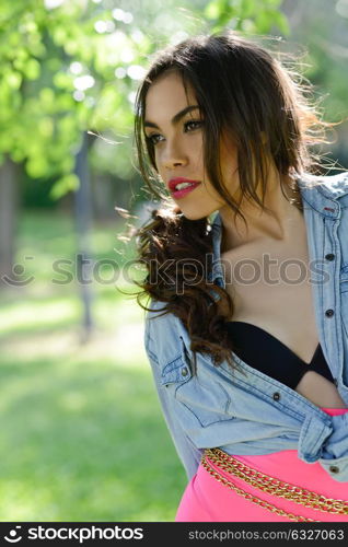 Portrait of a beautiful young woman, model of fashion, in a garden wearing pink panties