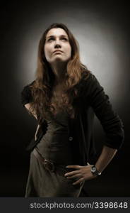 Portrait of a beautiful young woman on a dark background